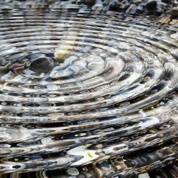 Ripples in clear water over stones