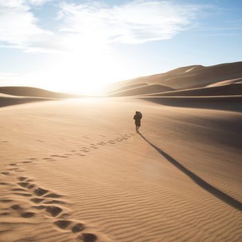 Person walking through a desert.