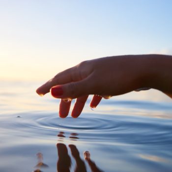 Hand touching water