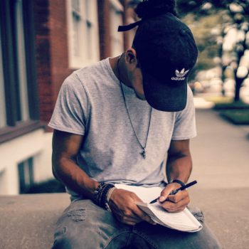 young man writing in a journal