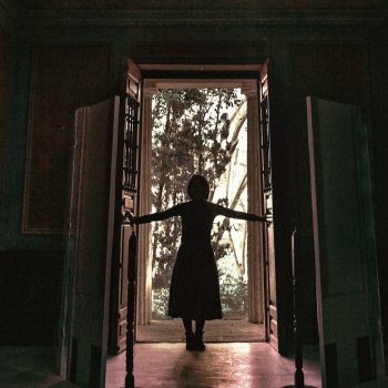 woman standing at open door.