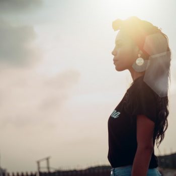 A woman's side profile as she looks to the left of the photo
