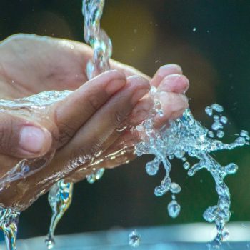 Hands under running water