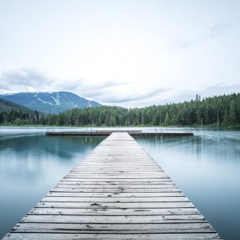 A long, light-colored dock extended out into calm water