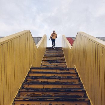 a person at the top of a long staircase