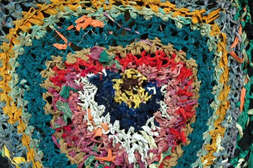 A colorful quilt made of knotted cloth