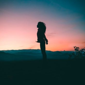 silhouette of a young person looking up into the sky
