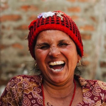A woman in a red hat laughing