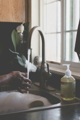 Person washing dishes by hand