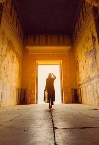 Woman stepping into a light-filled doorway