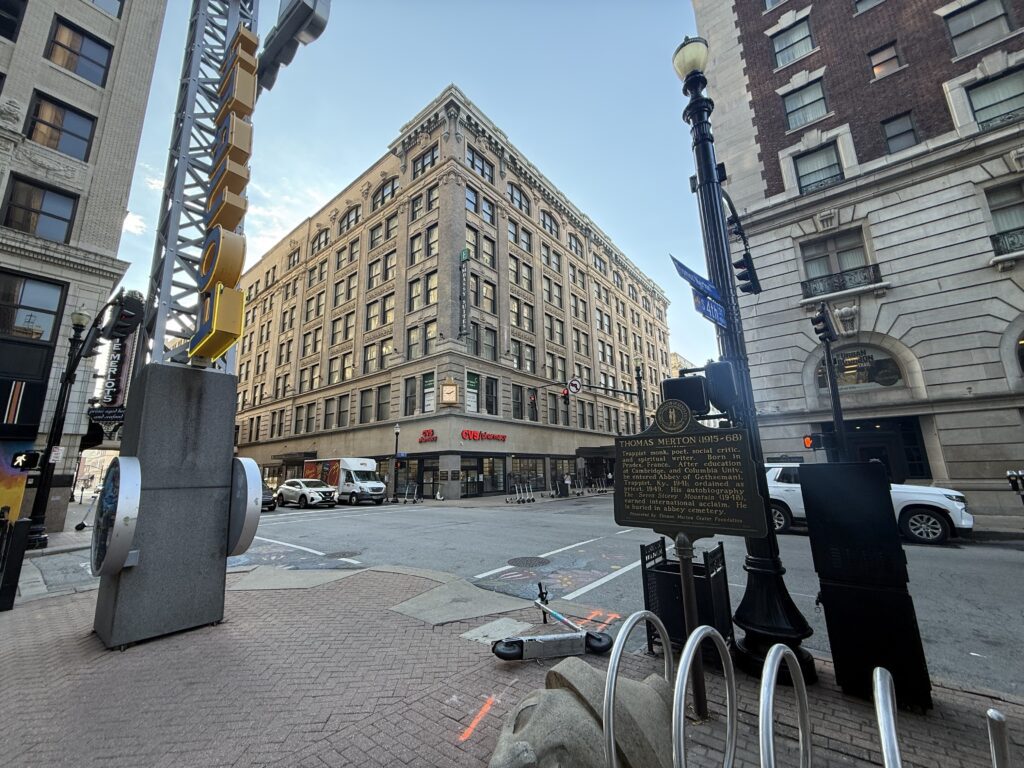 A plaque commemorating Thomas Merton at Walnut and 4th Street in Louisville, KY