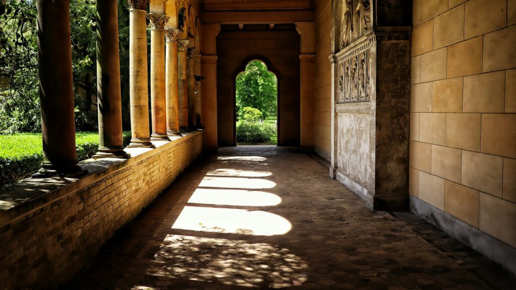 Stone walkway with pillars and sunlight on the floor